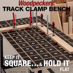 Mitered boards aligned to bench dogs and clamped with track clamps 